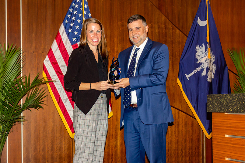 College of HRSM interim dean David Cardenas presents Houston Dash President & HDFC COO Jessica O'Neill the Distinguished Alumni in Sport and Entertainment award at the Sport Entertainment and Venues Tomorrow conference over Nov. 16-18, 2022, at the Columbia Metropolitan Convention Center.