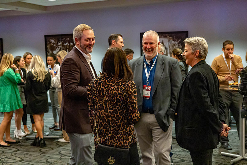 Four individuals speak with each other at the Sport Entertainment and Venues Tomorrow conference over Nov. 16-18, 2022, at the Columbia Metropolitan Convention Center.