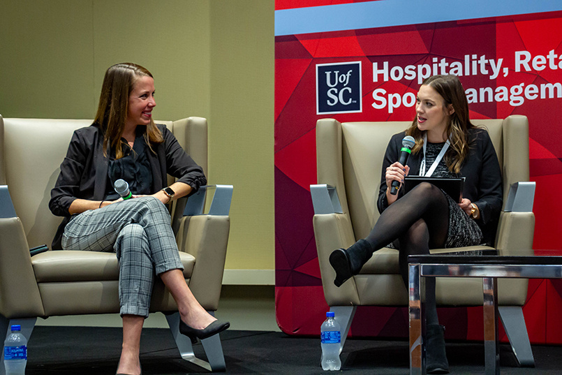 Keynote speaker Jessica O'Neill, Houston Dash President & HDFC COO, speaks on stage along with Ph.D. student Grace Kazmierski at the Sport Entertainment and Venues Tomorrow conference over Nov. 16-18, 2022, at the Columbia Metropolitan Convention Center.