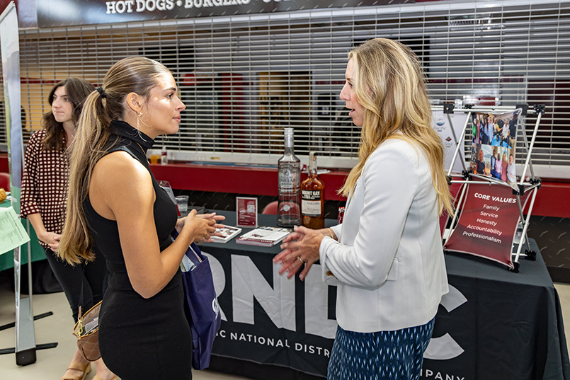 A rep from Republic National Distributing Company speaks to an HRSM student during the fall 2023 edition of Experience Expo.
