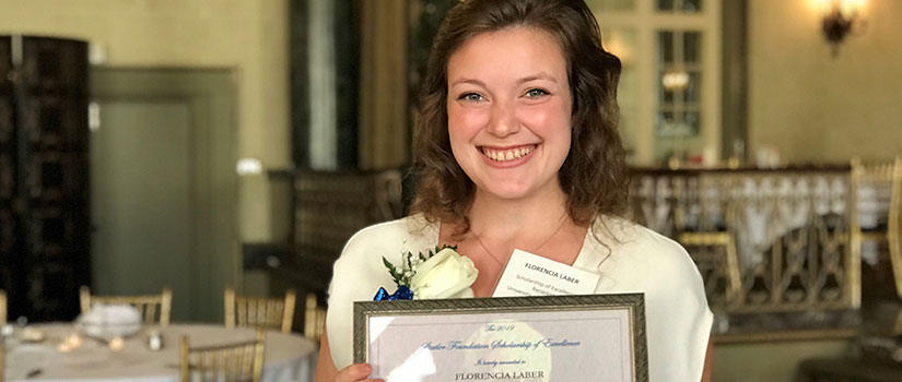 Florenica Laber proudly displays her $20,000 scholarship of excellence certificate awarded at the Statler Foundation's award ceremony. 