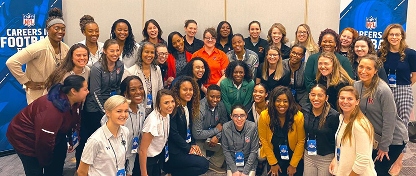 Kjahna O is seen posing with a large group of women at the NFL Women's Careers in Football Forum held in Indianapolis in February..