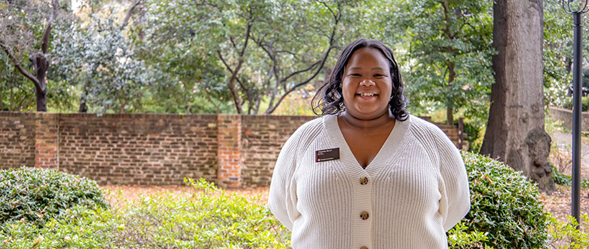 Alyssia Ross stands outside among the old-growth oaks and brick walls of UofSC's historic horseshoe