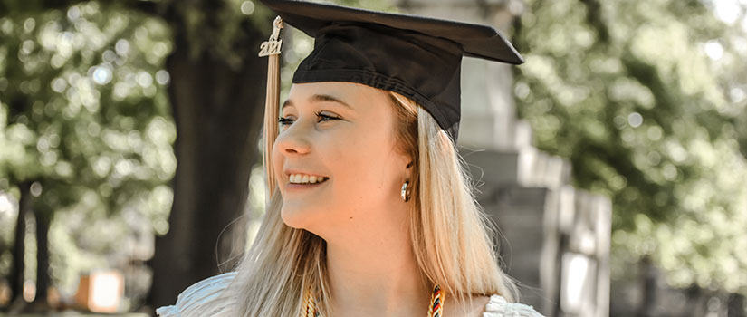 Headshot of Blair Snider wearing her 2021 graduation cap and tassel and honors cords
