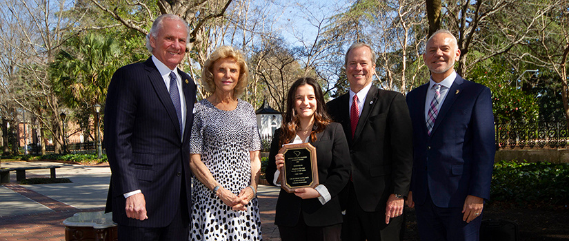 Meghan Keeler stands holding her award with S.C. Governor Henry McMaster, S.C. Department of Parks, Recreation and Tourism Director Duane Parrish and S.C. Restaurant and Lodging Association COO Douglas O'Flaherty on the Governor's mansion lawn.
