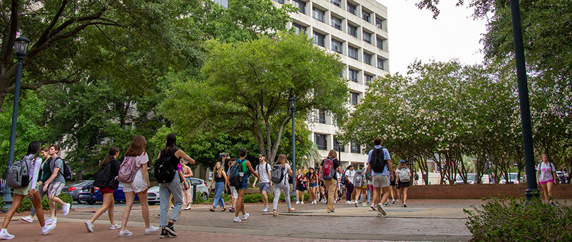 Students walk around outside the Close-Hipp Building on the first day of classes for the fall 2022 semester.
