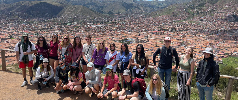Students posing at scenic overlook in Peru