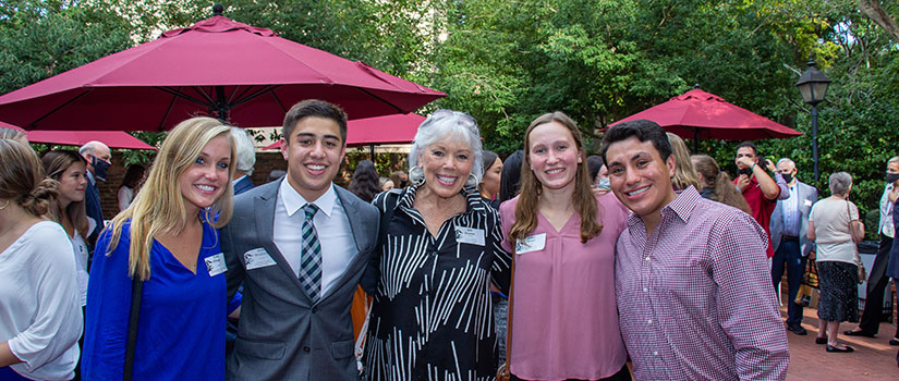 Scholarship recipients meet their benefactors at a reception on the patio at McCutchen House