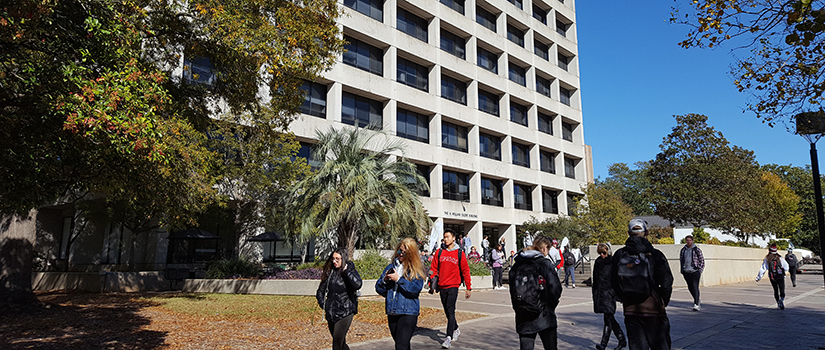 Exterior of Close-Hipp Building with students walking in foreground