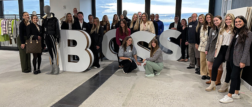 USC Department of Retailing students and faculty pose for a photo in the Hugo Boss showroom in New York City.