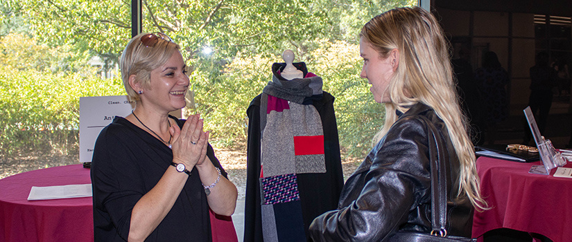 A local Columbia business owner speaks with an HRSM student at the Small Business Showcase during Retail Week.