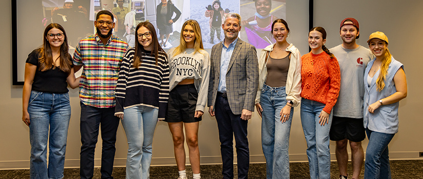 Delivering Good President & CEO Matthew Fasciano poses with Department of Retailing students