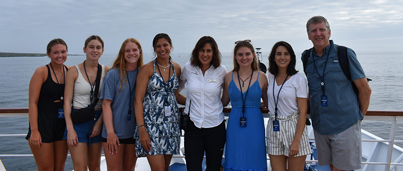 Kevin Ayres and students from HRSM pose aboard a ship in the Galapagos Islands.