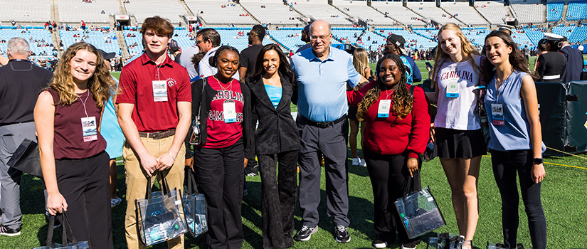 David and Nicole Tepper with the six newest Tepper Scholars at Bank of America Stadium