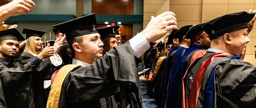 HRSM graduates sing the alma mater at a graduation ceremony