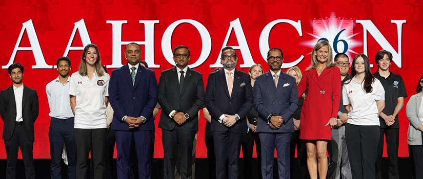 University of South Carolina hospitality management students Regan Lightfoot and Sophia Scimemi stand on stage with AAHOA leaders after receiving recognition during the 2026 AAHOA Convention & Trade Show in Philadelphia.