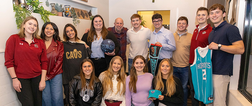 Group of University of South Carolina sport and entertainment management students celebrating job placements with industry mentor Murray Cohn