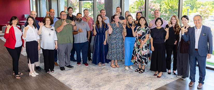 Faculty and staff from the University of South Carolina School of Hospitality and Tourism Management pose together for a group photo.