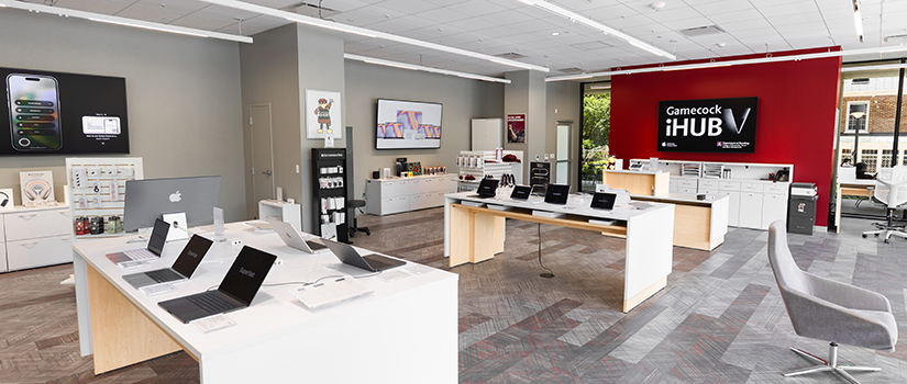 Wide view of the newly relocated Gamecock iHub, the University of South Carolina's Apple Authorized Campus Store, featuring Apple computers and accessories displayed throughout the modern retail space inside the Close-Hipp building.