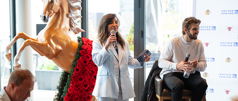 HRSM alumna Hillary McDonald speaks during a panel discussion at Chicago’s United Center while seated alongside another industry professional.