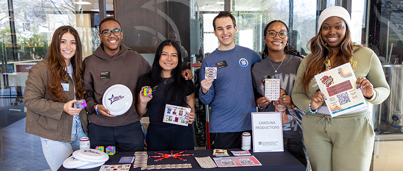 Branden Miller standing with fellow Carolina Productions student leaders at an event table promoting campus activities at the University of South Carolina.