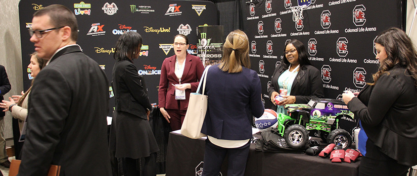 Exhiibitors from Disney and Colonial Life Arena talk to attendees at the SEVT Conference.