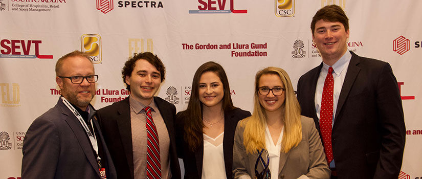 The 2021 SEVT Case Competition winning team stands holding their trophy