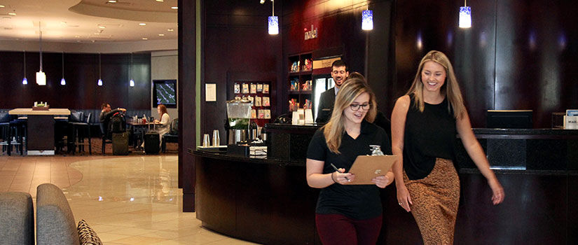 HRTM alumna and student walk together through the lobby of the Marriott Columbia.