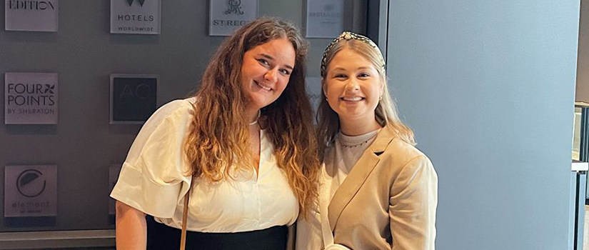 Grace Hutton and Caroline Aase pose for a photo together while attending the IHSC conference.