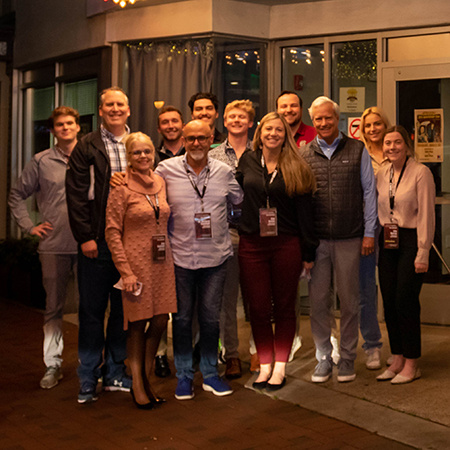 A group of people attending CSRI 2023 stand outside the Nickelodeon Theatre before watching an exclusive viewing of the movie Air.