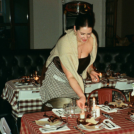 Maria Colalancia sets a table