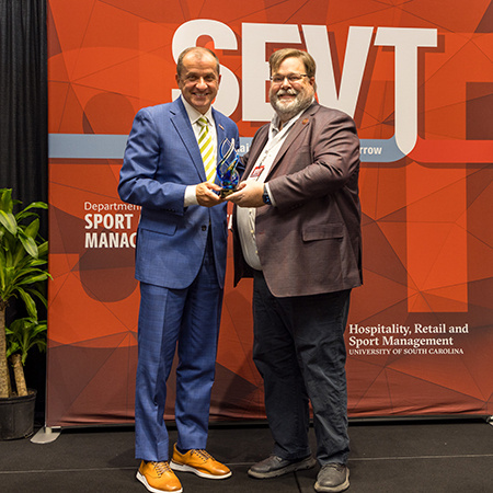 James Phillips receives an award from Matt Brown