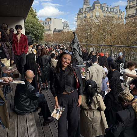 Isabel Stroth attending a Paris Fashion Week event with the Eiffel Tower visible in the background.