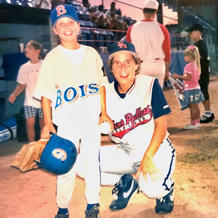 Michelle Delloso poses with a young baseball fan while playing for the Colorado Silver Bullets.