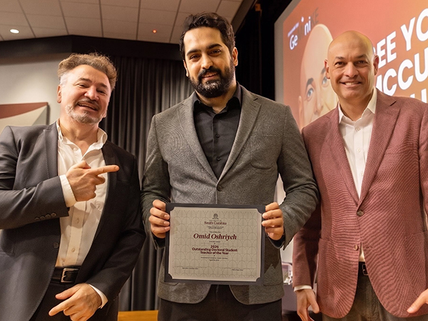 Omid Oshriyeh receives Outstanding Doctoral Student Teacher of the Year award holding certificate