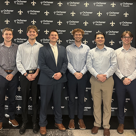 University of South Carolina alumni working with the New Orleans Pelicans pose together at an NBA team event.