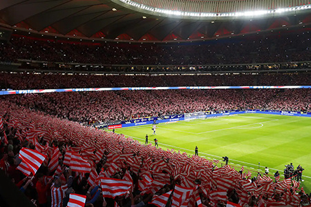A large crowd cheers on Atletico de Madrid at Civitas Metropolitan Stadium.