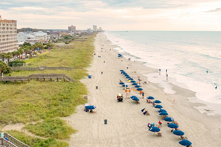 The shoreline of Myrtle Beach, South Carolina, dotted with umbrellas.