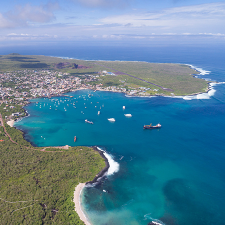 Aerial view of the small town of Puerto Baquerizo Moreno with airstrip and its beautiful beaches, San Cristobal, Galapagos Islands, Ecuador
