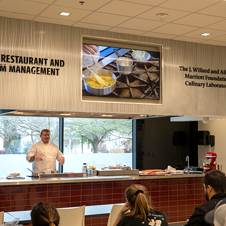 Students listen to an instructor at the Marriott Culinary Lab.