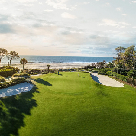 An aerial view of a green on a golf course with the ocean in the background at The Sea Pines Resort on Hilton Head Island, South Carolina.