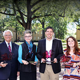 2017 Distinguished Alumni and Friends of the College award winners stand on thoe horseshoe holding their awards