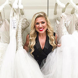 Hunter Bailey stands surrounded by wedding gowns at Kleinfeld Bridal in NYC