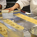 Detail of culinary and beverage class with students making pasta