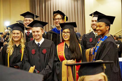Hooding and Cording group pose for a photograph
