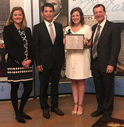 Florencia Laber stands with College of HRSM Dean Haemoon Oh, Director of HRSM Development Katye Daley and her father, Edgardo Laber, at the scholarship awards ceremony