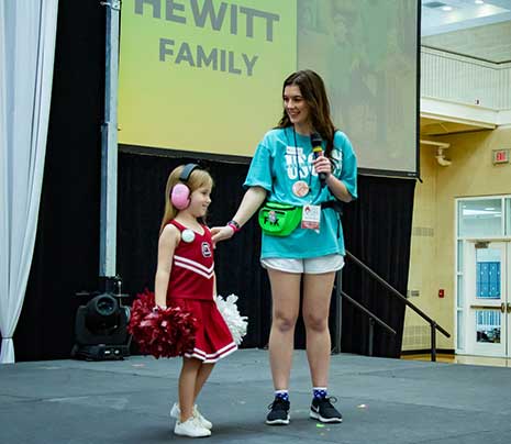 Taking the stage with a future Gamecock child who is a member of a Miracle Family, Sara Pollin heads up a team coordinating the UofSC Dance Marathon.