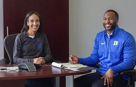Jarett Geralds laughs with a few other athletics professions during a tv presentation for the Duke Blue Devils