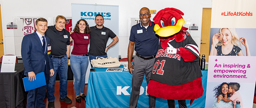 Members of Kohl's pose for a photo with Cocky at Experience Expo