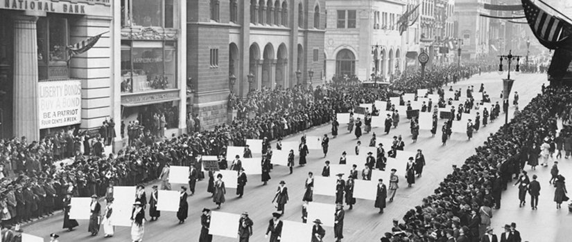 Suffragists march in October 1917, displaying placards containing the signatures of over one million New York women demanding to vote.
